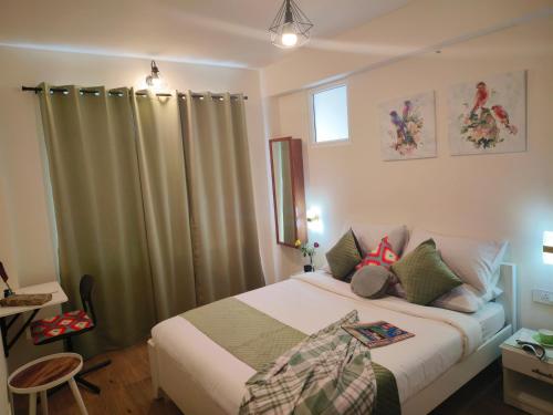 a bedroom with a bed with curtains and a table at Hope Horizon Villa Coonoor by LexStays in Coonoor