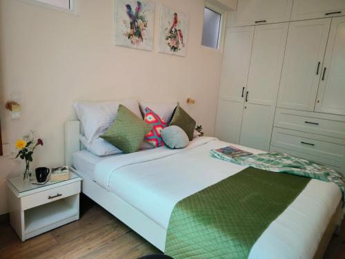 a bedroom with a large white bed with pillows at Hope Horizon Villa Coonoor by LexStays in Coonoor