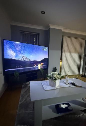 a living room with a large flat screen tv at The Heart of Birmingham City Centre in Birmingham