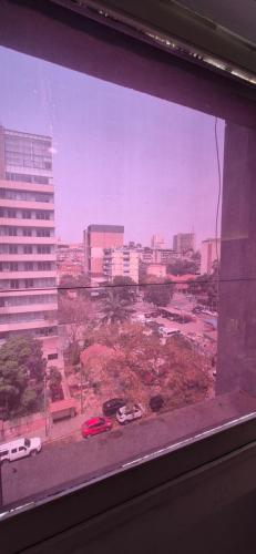 a view of a city from a window at Apartamento T2 in Luanda