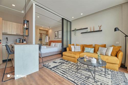 a living room with a couch and a table at Stayhere Casablanca - Palmier - Executive Residence in Casablanca