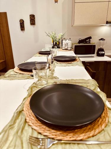 a table with a black plate on top of it at Jungle Guardian - Rooftop Pool & Beach Club in Zona Hotelera Tulum in Tulum