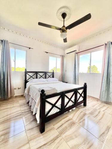 a bedroom with a bed and a ceiling fan at Beautiful and confortable apt in Puerto Plata