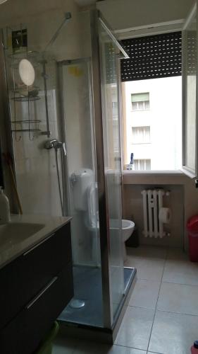 a bathroom with a glass shower and a sink at YiJia - Locazione Turistica in Padova