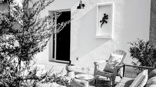 a patio with two chairs and a table and a window at LE CEMAROSE Cottage & Spa Terrace Garden & lovely View in Épernay
