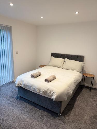a bed with two pillows on it in a bedroom at 3 Bedroom House with free on site Parking next to the Canal in Keighley