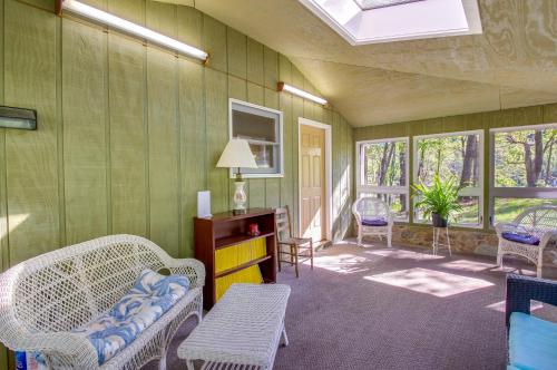 a living room with wicker chairs and a table at Shenandoah National Park Cabin with Patio! in McGaheysville