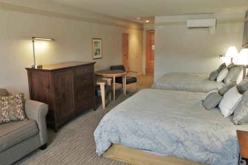 a hotel room with two beds and a couch at Silver Bay YMCA Inn and Conference Center in Silver Bay