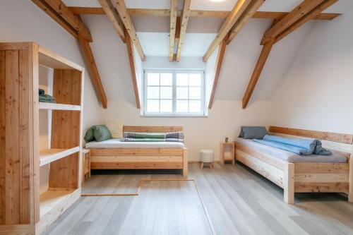 a bedroom with two beds and a window at Franzlhof Appartements in Stainz