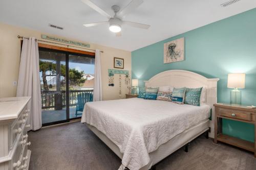 a bedroom with a large bed and a window at SDG2 Sea Glass Shack in Kitty Hawk