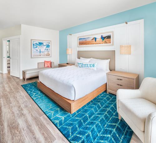 a bedroom with a large bed and a couch at Margaritaville Hotel Kansas City in Kansas City