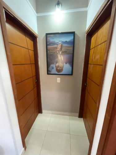 a hallway in a house with a painting on the wall at casa Belo Horizonte · Casa 3 quartos parte superior individual com suite in Indaiatuba