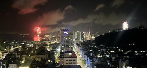 a view of a city at night with fireworks at Căn Hộ Hướng Biển Xem pháo hoa gần Vincom,Bảo Tàng Quảng Ninh in Ha Long