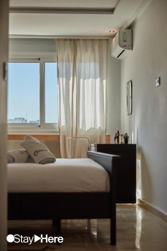 a bedroom with a bed and a window at Stayhere Rabat - Hassan - Authentic Residence in Rabat