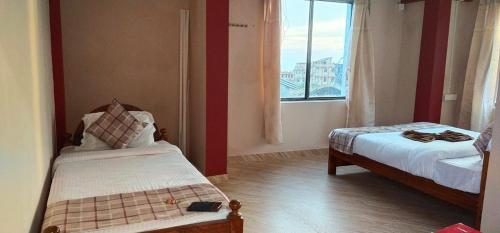 Кровать или кровати в номере Arara Group Stays Cottage