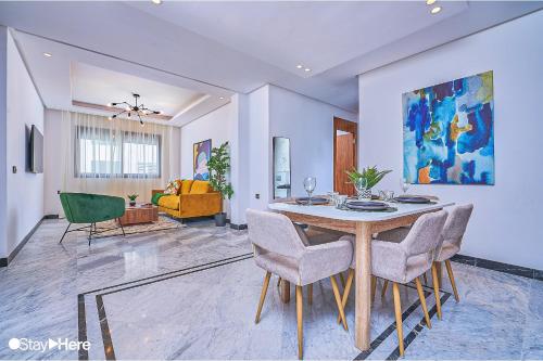 a dining room with a table and some chairs at Stayhere Rabat - Hay Riad - Sophisticated Residence in Rabat
