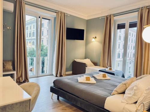 a hotel room with a bed and a couch at San Pietro Rooms 84 in Rome
