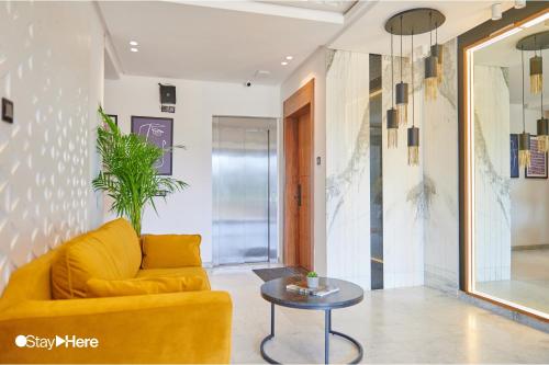 a living room with a yellow couch and a table at Stayhere Rabat - Hay Riad - Sophisticated Residence in Rabat