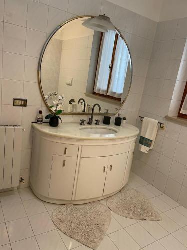 a bathroom with a sink and a mirror at Casa Vacanza Patrizia in Bastia Umbra
