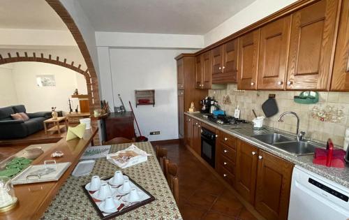 a kitchen with wooden cabinets and a counter top at Casa Vacanza Patrizia in Bastia Umbra
