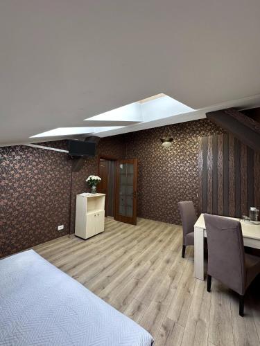 a room with a table and chairs and a ceiling at Hotel Plazma in Lviv
