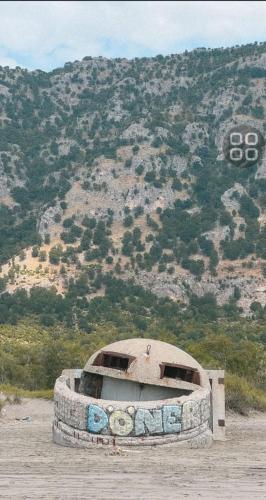 an old tire sitting in front of a mountain at Villa 176 in Baks-Rrjoll