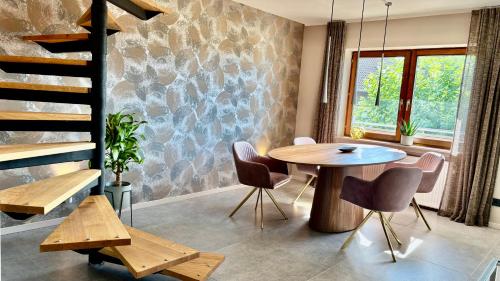 una sala da pranzo con tavolo e sedie in legno di Heaven Homes XL - Luxusoase Balkon Parkplatz a Bad Camberg