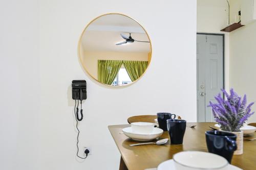 a mirror on a wall above a table with dishes at Blissful Escape Perfect Homestay for Families & Friends Brinchang Clover Home 3-03A in Brinchang