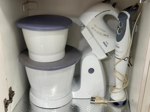 two white appliances are sitting in a drawer at Apto 1 dorm no Canto do Forte - Próximo a Praia! in Praia Grande