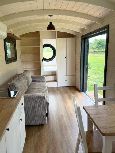 a living room with a couch and a table at Maringotka Zdenička in Petrovice u Susice