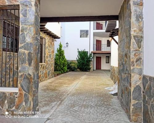 a stone alley with a building in the background at Sierra y Silencio Nómada, WIFI, Trastero y Garaje in Güéjar-Sierra
