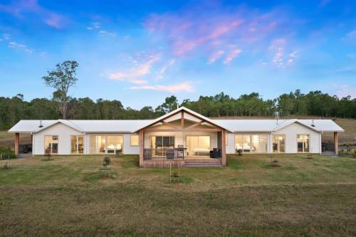 a large house with a large yard at The Shiraz Villa at Molly Morgan Wines in Rothbury