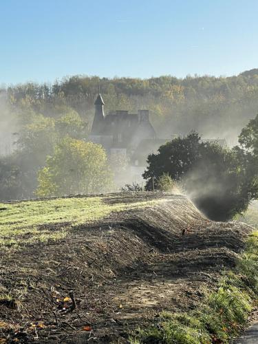 a house on top of a field in the fog at Le Cottage enchanteur du Renouard avec sa Vue panoramique in Le Renouard