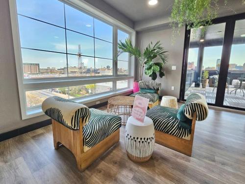 a living room with couches and a large window at Central Philly 1Br Apt with Gym in Philadelphia