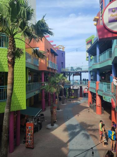 a group of buildings with palm trees and a bridge at -New Listing- Completely Remodeled and Newly Furnished 3BR Direct Ocean Front Condo in Seabreeze
