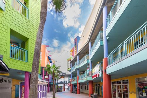 a row of colorful buildings on a street at -New Listing- Completely Remodeled and Newly Furnished 3BR Direct Ocean Front Condo in Seabreeze