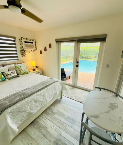 a bedroom with a bed and a view of a pool at Dockside dreams in West Palm Beach