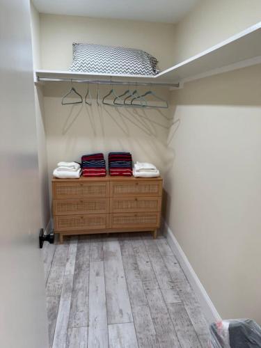 a walk in closet with a wooden dresser and towels at Dockside dreams in West Palm Beach