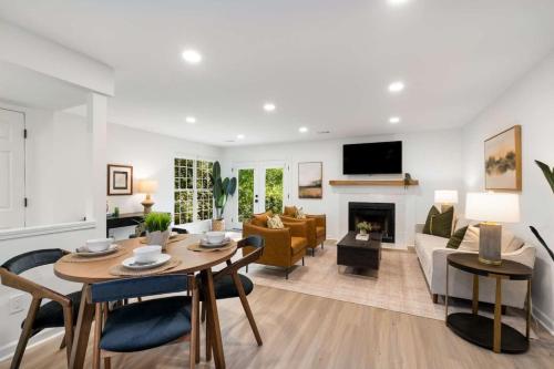 a living room with a table and a couch at Stroll to Downtown Alpharetta AND Avalon Shops in Alpharetta