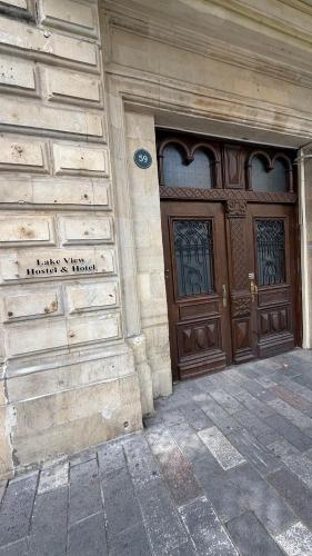 a building with two large wooden doors on it at Lake View Hostel & Hotel baku in Baku