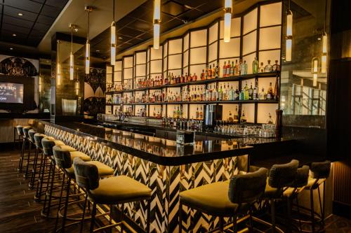 a bar with a row of bar stools at Hard Rock Hotel & Casino Tulsa in Tulsa