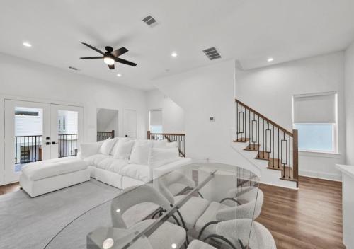 a living room with white furniture and a ceiling fan at Modern Home Suite, 2BR, Office, Near Galleria in Houston