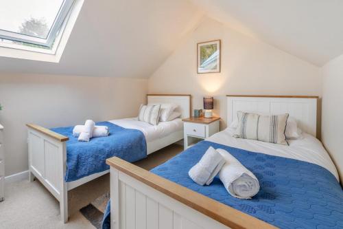 two beds in a room with two windows at 3 Bed in Beer oc-f32429 in Beer