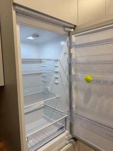 an empty refrigerator with a tennis ball in it at poilsio ramybes oaze in VNO