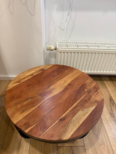 a wooden table sitting on the floor in a room at poilsio ramybes oaze in VNO
