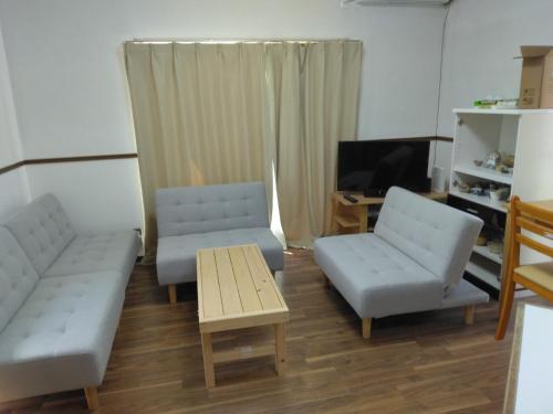 a living room with a couch and two chairs and a table at Townhouse No, 3 - Vacation STAY 43084v in Sanuki