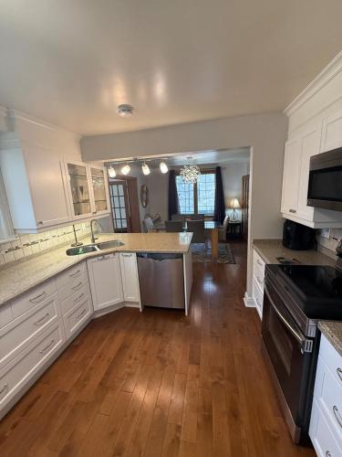 a kitchen with white cabinets and a counter top at Spacious 5-Bedroom House in Thornhill in Vaughan