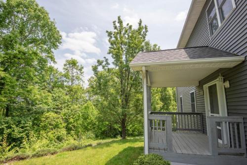 a porch of a house with at Mountain Top Lodge with Views - Hot Tub, River Access, 15 Mins to West Jefferson in Crumpler