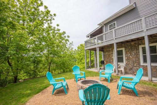a group of chairs sitting around a fire pit in front of a house at Mountain Top Lodge with Views - Hot Tub, River Access, 15 Mins to West Jefferson in Crumpler