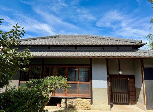 a small house with a window and a roof at Whole house rental "Atori" - Vacation STAY 45535v in Ieura